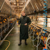 the No Sweat Stormgear Waterproof Dairy Gown in use in a milking parlour 